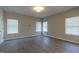Bright bedroom with neutral paint, large windows with blinds, and luxury vinyl plank flooring at 144 E Victory View Ter # 66, Smithfield, NC 27577
