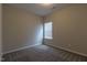 Carpeted bedroom featuring neutral walls and a window at 144 E Victory View Ter # 66, Smithfield, NC 27577