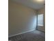 Carpeted bedroom featuring neutral walls and a window at 144 E Victory View Ter # 66, Smithfield, NC 27577