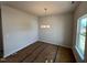 Dining room featuring a modern light fixture, neutral paint, and large window at 144 E Victory View Ter # 66, Smithfield, NC 27577