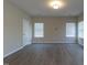 Bright living room featuring light gray walls, wood floors, and lots of natural light from multiple windows at 144 E Victory View Ter # 66, Smithfield, NC 27577