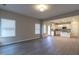 Bright living room featuring luxury vinyl plank floors and a view of the open concept kitchen at 144 E Victory View Ter # 66, Smithfield, NC 27577