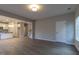 Open-concept living room showcasing luxury vinyl plank floors and a view of the bright kitchen at 144 E Victory View Ter # 66, Smithfield, NC 27577
