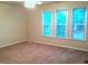 Bright bedroom featuring three large windows and neutral carpet at 1505 Harth Dr, Garner, NC 27529