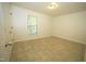 Neutral bedroom featuring tile flooring and a window at 1505 Harth Dr, Garner, NC 27529