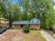 Charming home featuring a brick facade, complemented by well-maintained landscaping and a serene wooded backdrop at 1505 Harth Dr, Garner, NC 27529