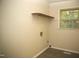 A compact laundry room featuring a folding table and natural light from the window at 1505 Harth Dr, Garner, NC 27529