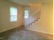 Inviting living room with staircase and a view of the front entry door at 1505 Harth Dr, Garner, NC 27529
