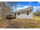 Exterior back view of house, features the wooden deck, lawn, and windows at 188 Hunter Ln, Zebulon, NC 27597