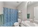 Neat bathroom with a blue shower curtain, vanity, and toilet for essential comfort at 188 Hunter Ln, Zebulon, NC 27597