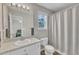 Well-lit bathroom with a vanity, toilet, and shower, offering a clean and functional space at 188 Hunter Ln, Zebulon, NC 27597