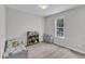 Charming bedroom featuring carpeted floors, natural light, and playful decor at 188 Hunter Ln, Zebulon, NC 27597