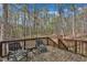 Relaxing deck with seating surrounded by trees offers a serene outdoor living space at 188 Hunter Ln, Zebulon, NC 27597