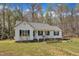 Beautiful one-story house with white walls, a nice porch, and a yard ready for gardening at 188 Hunter Ln, Zebulon, NC 27597