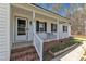Inviting covered front porch with brick steps, white railings, and a charming address marker at 188 Hunter Ln, Zebulon, NC 27597