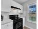 Kitchen features include granite countertops, black oven range and hood, white cabinets, and bright window at 188 Hunter Ln, Zebulon, NC 27597