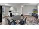 Open kitchen and dining area featuring a black table with seating, modern appliances, and easy access to living room at 188 Hunter Ln, Zebulon, NC 27597