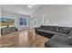 Bright living room with vaulted ceiling, luxury vinyl floors, large windows, and comfortable sectional sofa at 188 Hunter Ln, Zebulon, NC 27597