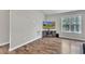 Well-lit living room with luxury vinyl flooring, neutral walls, and entertainment center, ready for relaxation and entertainment at 188 Hunter Ln, Zebulon, NC 27597