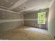Empty bedroom awaits finishing with natural light streaming from a window with views of the trees at 1945 Cranes Creek Rd, Cameron, NC 28326