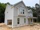 Light gray two-story home featuring a side entry garage and covered porch at 1945 Cranes Creek Rd, Cameron, NC 28326