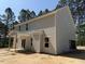 A two-story home displays gray siding, a covered porch, and windows with views of surrounding trees at 1945 Cranes Creek Rd, Cameron, NC 28326