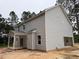Side view of a light gray two-story home featuring a garage and covered porch at 1945 Cranes Creek Rd, Cameron, NC 28326