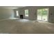 Unfinished living room featuring two windows and a sliding glass door at 1945 Cranes Creek Rd, Cameron, NC 28326