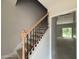 Interior staircase featuring iron spindles and wood railing at 1945 Cranes Creek Rd, Cameron, NC 28326