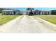 Charming duplex featuring a long driveway, well-manicured lawn and matching blue doors at 20 Chaney Ln, Louisburg, NC 27549