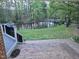 Scenic view from patio overlooking a pond surrounded by lush greenery and mature trees at 2000 Mountain Laurel Dr, Clayton, NC 27527