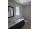 Well-lit bathroom with a double-sink vanity, neutral color scheme, and window, offering a practical yet serene space at 2000 Mountain Laurel Dr, Clayton, NC 27527