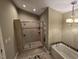 Bathroom featuring tiled shower with glass doors, jacuzzi tub and neutral color palette at 2000 Mountain Laurel Dr, Clayton, NC 27527
