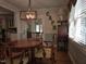 Cozy dining room with hardwood floors, a decorative light fixture, and vintage furniture at 2000 Mountain Laurel Dr, Clayton, NC 27527