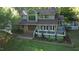 Charming two-story home features a spacious deck and manicured lawn surrounded by mature trees at 2000 Mountain Laurel Dr, Clayton, NC 27527