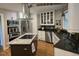 Well-equipped kitchen with stainless steel appliances, an island cooktop, and custom cabinetry at 2000 Mountain Laurel Dr, Clayton, NC 27527