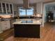 Bright kitchen features an island, stone countertops, stainless appliances, and white cabinetry at 2000 Mountain Laurel Dr, Clayton, NC 27527