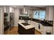 Modern kitchen with stainless steel appliances, an island cooktop, and custom cabinetry at 2000 Mountain Laurel Dr, Clayton, NC 27527