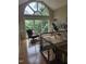 Bright loft space with a large arched window offering views of the trees, complemented by elegant seating at 2000 Mountain Laurel Dr, Clayton, NC 27527