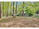 Spacious backyard surrounded by lush trees provides an idyllic backdrop for outdoor living and entertainment at 201 Wortham Dr, Raleigh, NC 27614
