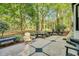 Well-maintained backyard features a concrete patio with benches and shade trees creating an inviting outdoor space at 201 Wortham Dr, Raleigh, NC 27614