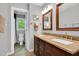 Well-lit bathroom features double sinks with granite countertop, framed mirrors, and a separate toilet area at 201 Wortham Dr, Raleigh, NC 27614