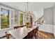 Elegant dining room features hardwood floors, large windows, and classic wainscoting at 201 Wortham Dr, Raleigh, NC 27614