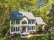 An eye-level view of a charming two-story home featuring a well-maintained lawn and mature trees around the property at 201 Wortham Dr, Raleigh, NC 27614