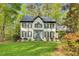 Charming two-story home with black trim, surrounded by lush greenery, and professionally landscaped at 201 Wortham Dr, Raleigh, NC 27614