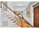 Inviting foyer with hardwood floors and staircase leads to bright dining area, offering a warm welcome at 201 Wortham Dr, Raleigh, NC 27614