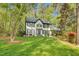 A manicured front lawn and mature trees frame a beautiful home with classic architectural details at 201 Wortham Dr, Raleigh, NC 27614