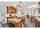 Open-concept kitchen features granite countertops, center island with cooktop, and a view of the cozy living area at 201 Wortham Dr, Raleigh, NC 27614