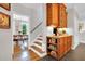 Kitchen cabinet storage with under cabinet lighting adjacent to staircase and an entrance to a separate eating area at 201 Wortham Dr, Raleigh, NC 27614