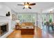 Bright living room featuring hardwood floors, a fireplace, and shuttered windows at 201 Wortham Dr, Raleigh, NC 27614
